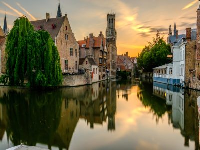 Bruges (Brugge) cityscape with water canal at sunset