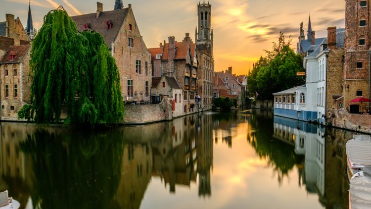 Bruges (Brugge) cityscape with water canal at sunset